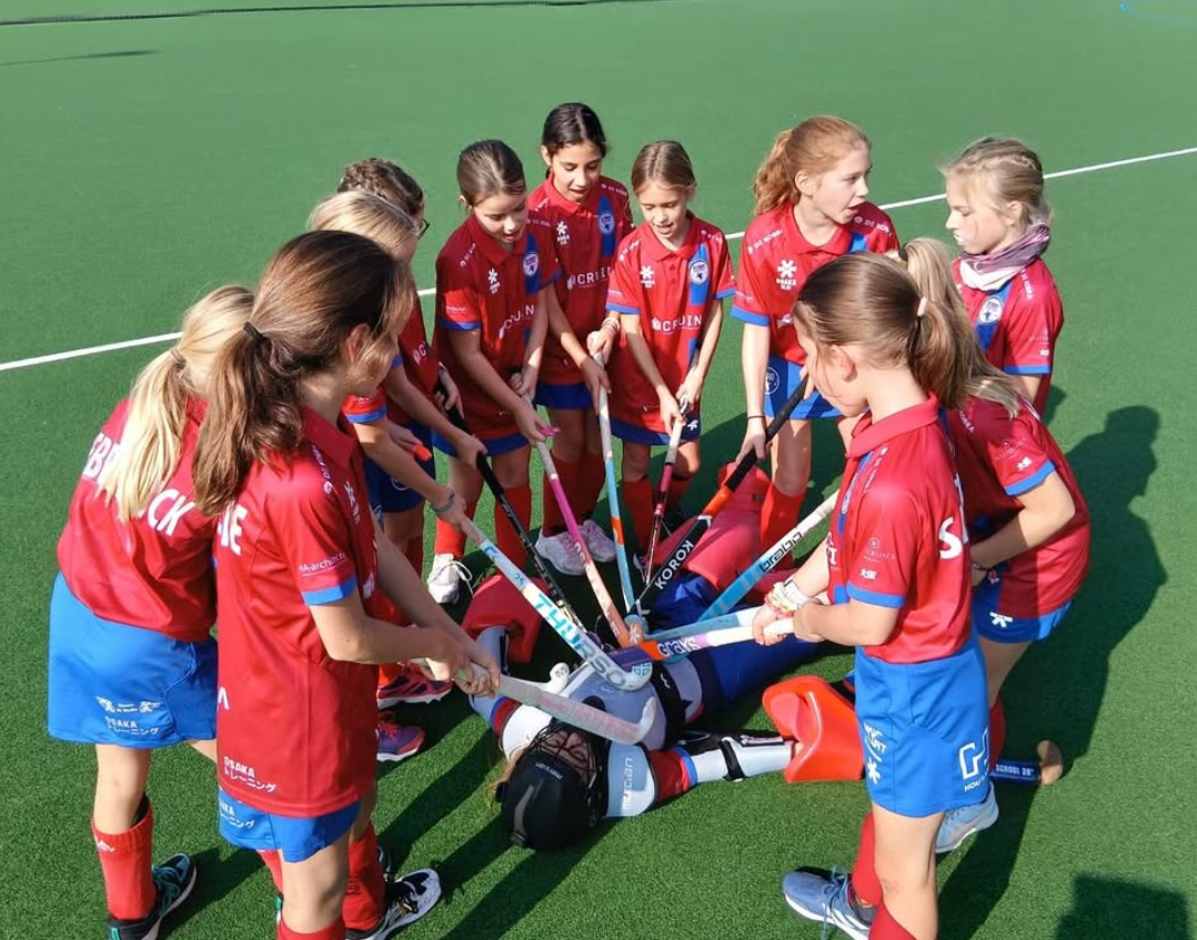 Meisjes in cirkel met sticks - D-mon Hockey Club